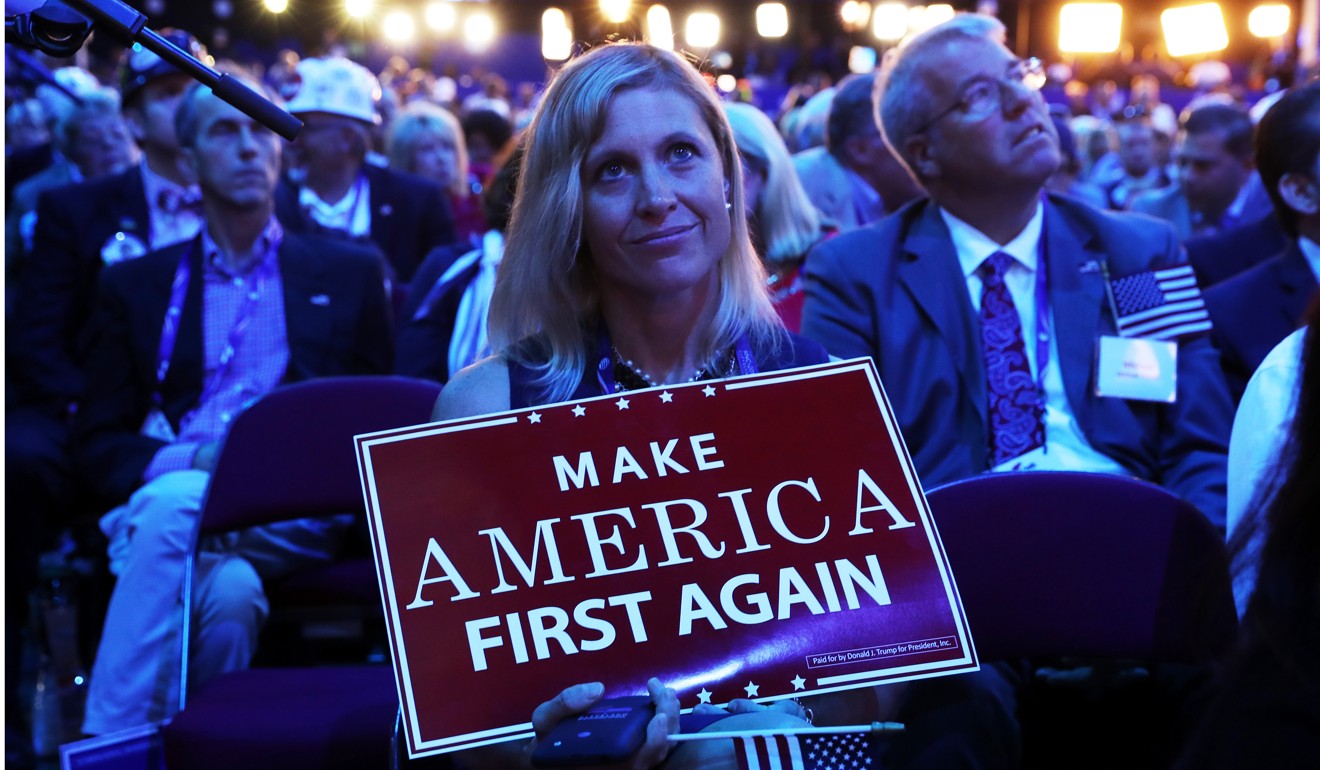 A delegate holds up a sign at the Republican National Convention in 2016. Photo: AFP