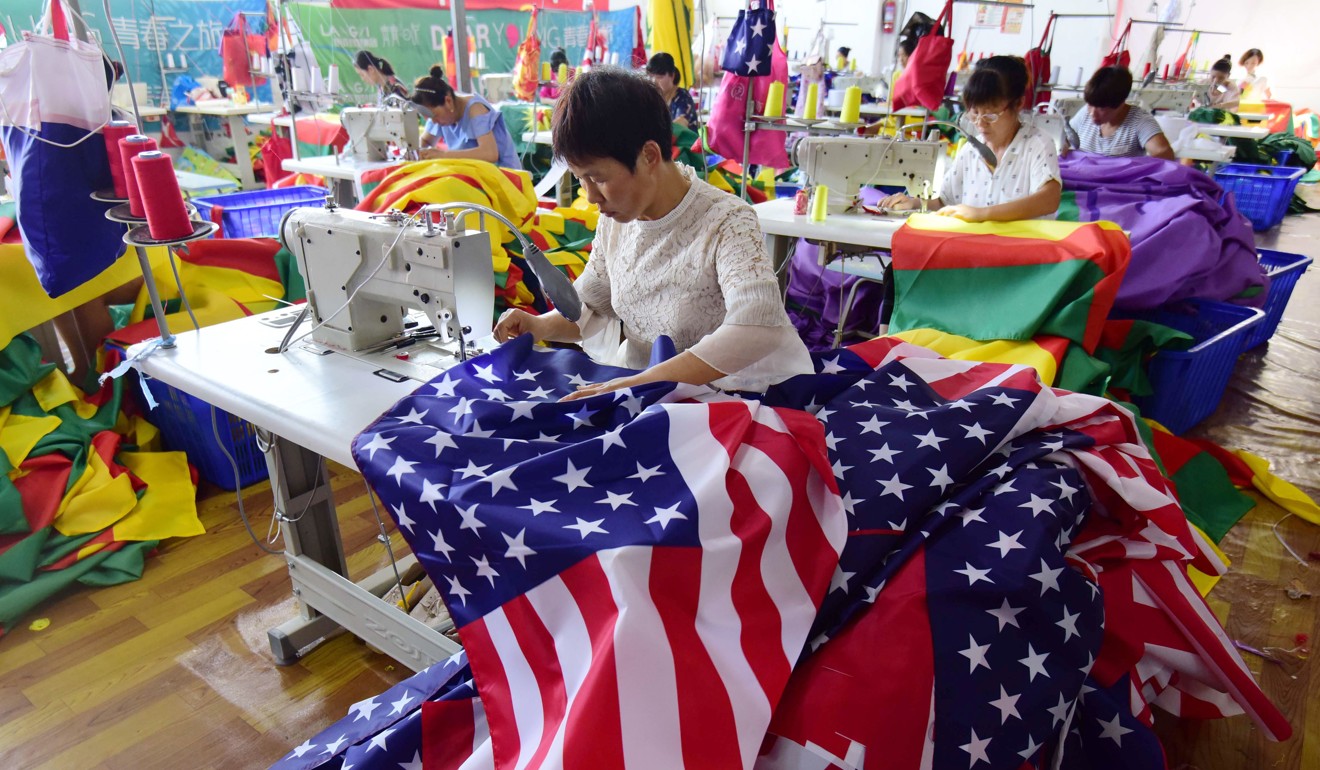 Chinese employees sew US flags at a factory in Fuyang in China's eastern Anhui province. Photo: AFP