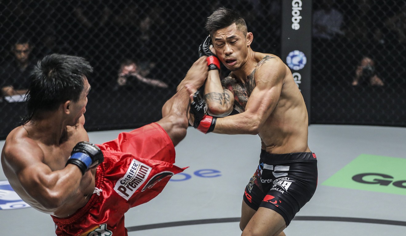 Kevin Belingon of the Philippines lands a left foot as Martin Nguyen covers up during their bantamweight clash.