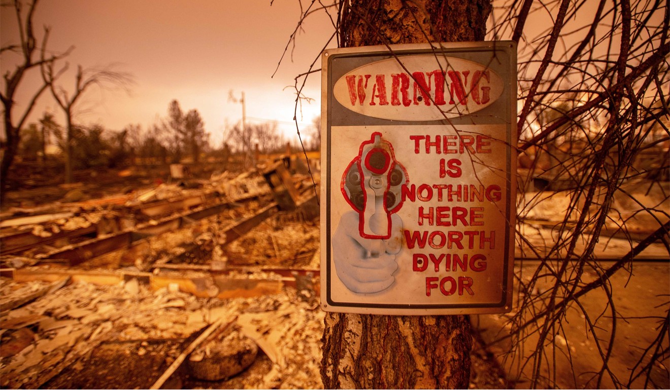 A sign posted outside the ruins of a house burned down during the Carr Fire in Redding, California on July 27, 2018. Photo: AFP