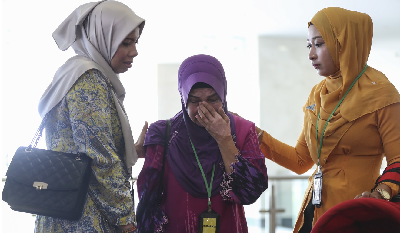 Sarah Nor (centre), the mother of passenger Norliakmar Hamid, cries at the Ministry of Transport headquarters in Putrajaya, Malaysia, July 30, 2018. Photo: EPA