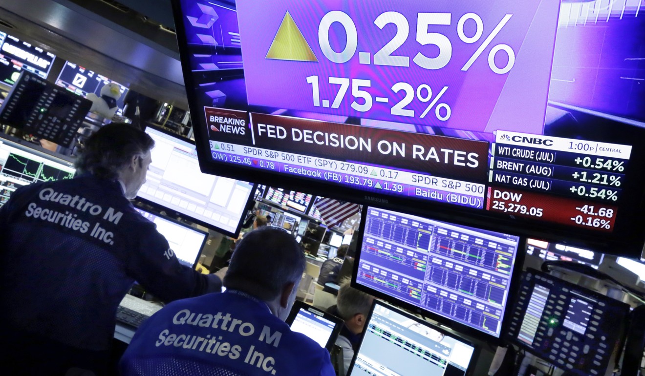 A screen on the floor of the New York Stock Exchange shows the rate decision of the Federal Reserve on June 13. After decades of low interest rates, the US central bank is gradually normalising rates. Photo: AP