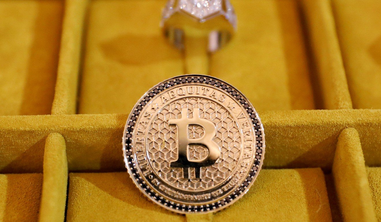 Jewelry with the bitcoin logo is seen on display at a conference on blockchain technology in New York in May. Although regulators are ambivalent about bitcoin and other cryptocurrencies, blockchain – the technology that underpins digital currencies – has been more widely embraced. Photo: Reuters