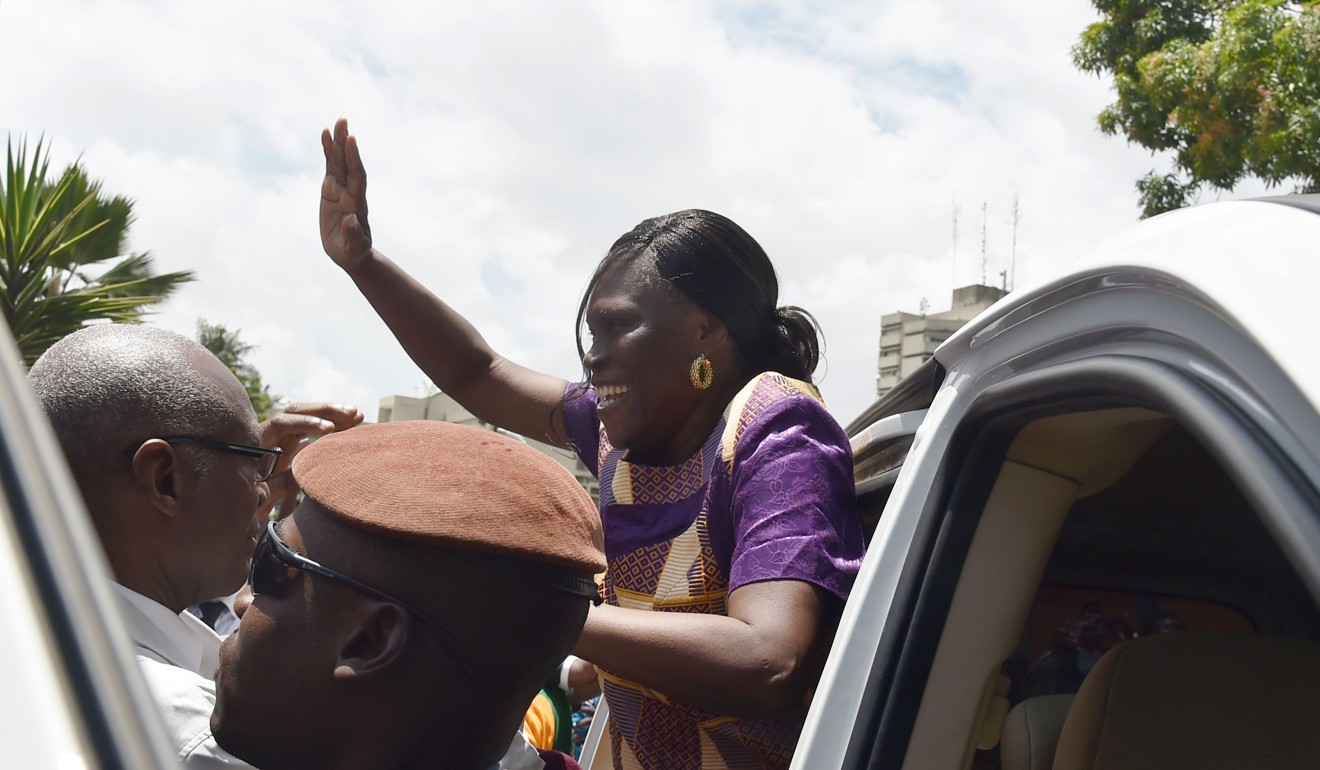Former Ivory Coast first lady Simone Gbagbo is greeted as she arrives at her home after she was released from prison. Photo: Agence France-Presse