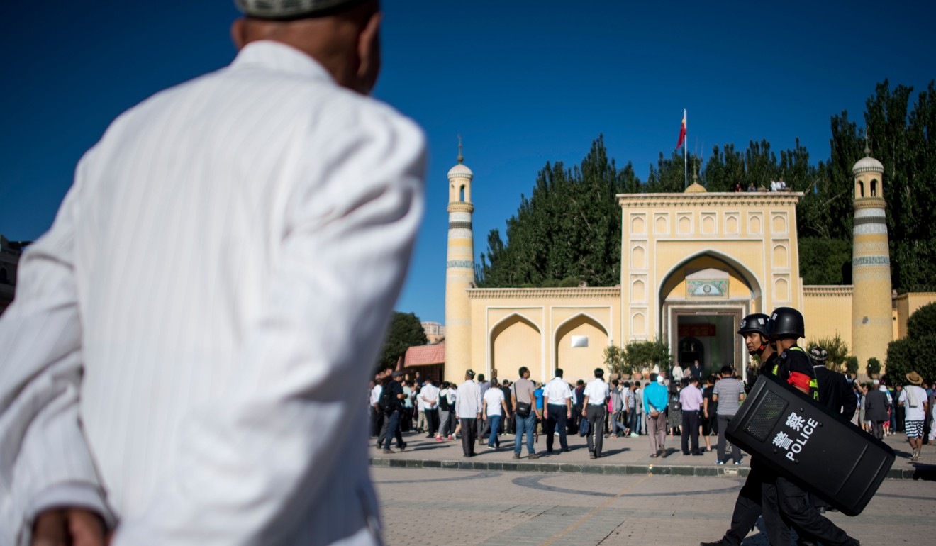 Muslim men arriving at the Id Kah Mosque for the morning prayer on Eid al-Fitr in Kashgar. Photo: AFP