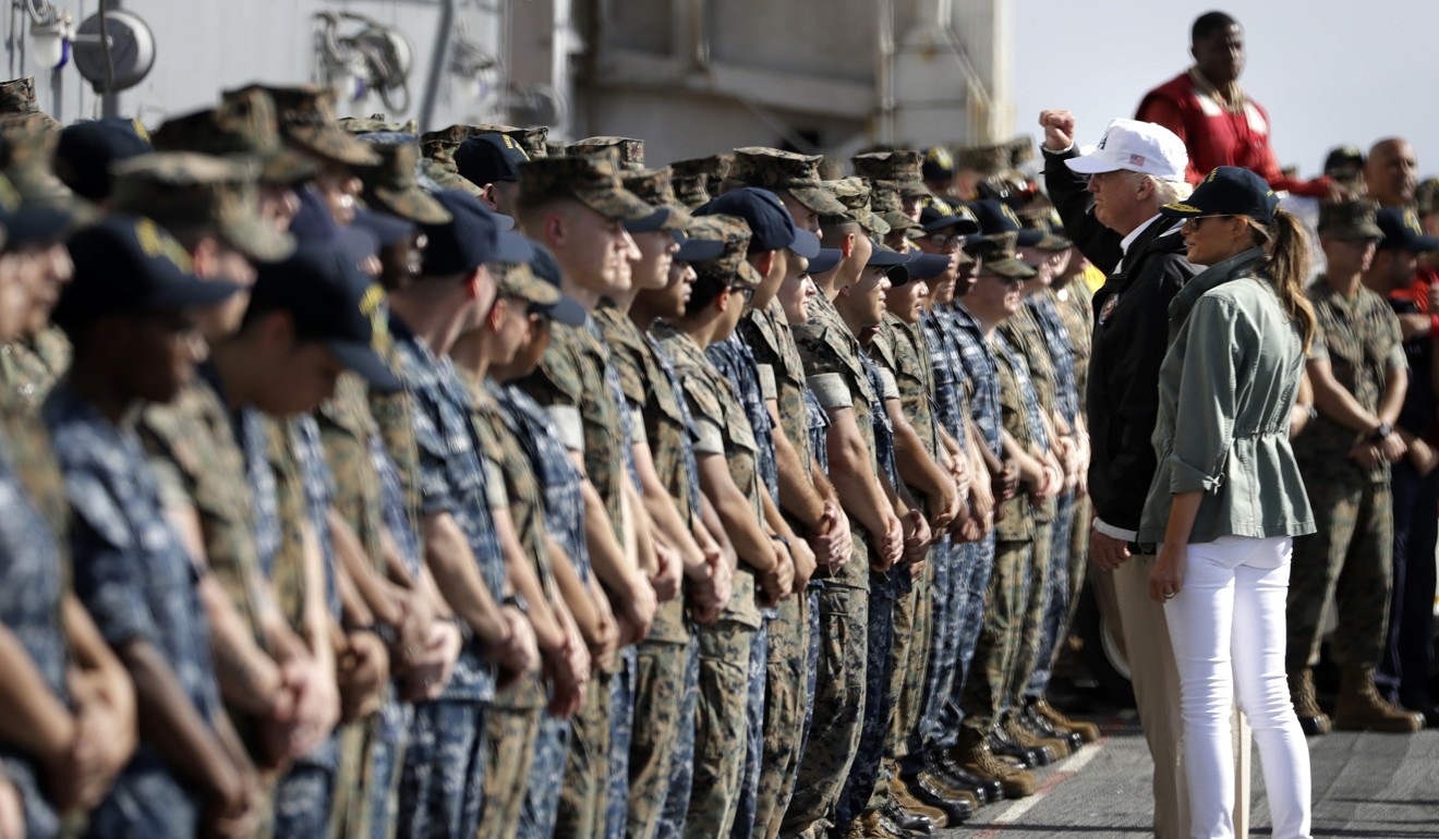 President Donald Trump and first lady Melania Trump greet military members on the USS Kearsarge off the coast of San Juan, Puerto Rico, on October 3, 2017. Photo: AP