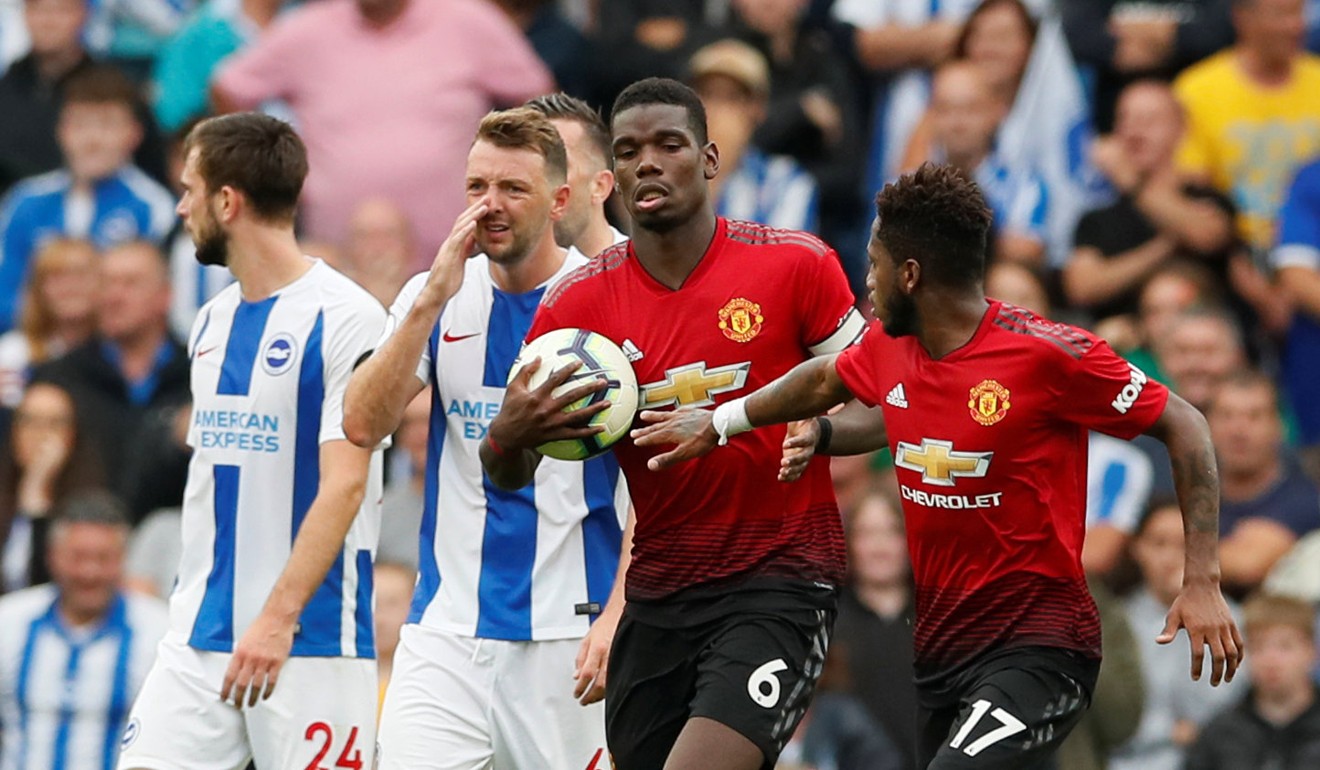 Pogba runs back with the ball after scoring from the penalty spot at Brighton. Photo: Reuters