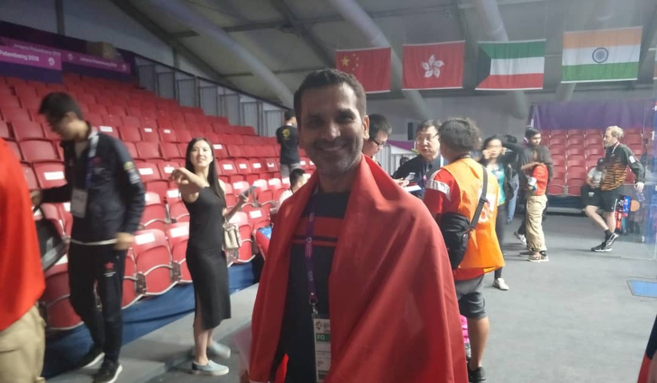 Coach Faheem Khan with the Hong Kong flag.