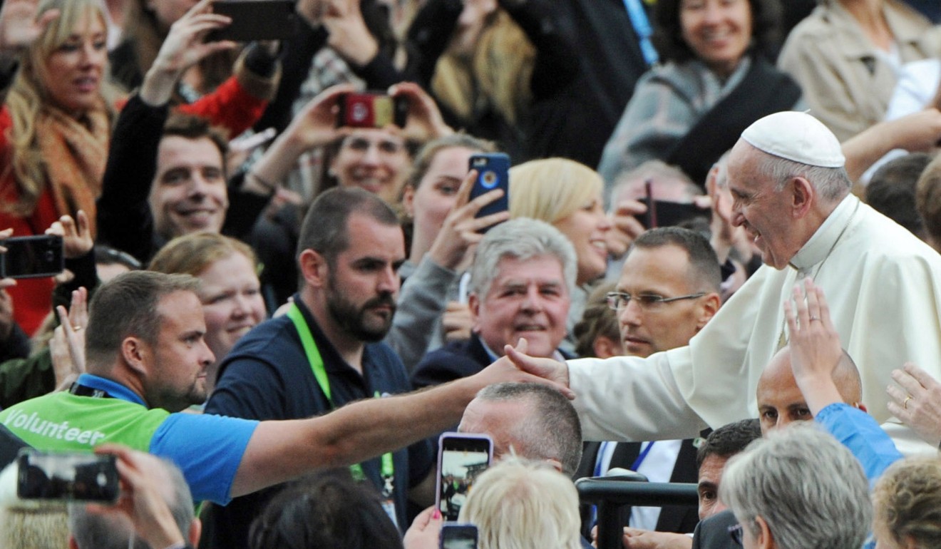 Pope Francis greets faithful during the World Meeting of Families event in Croke Park Stadium in Dublin. Photo: EPA