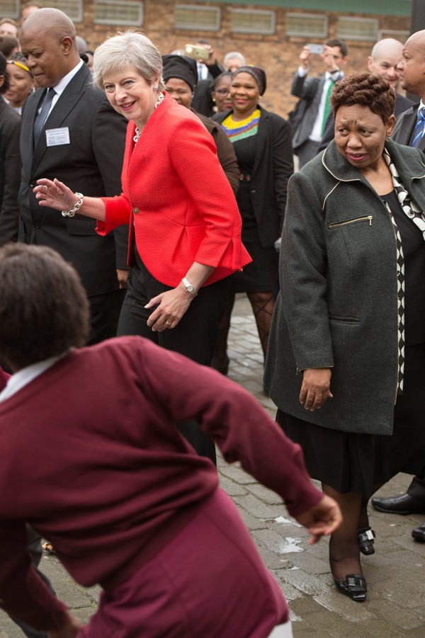 Britain's Prime Minister Theresa May dances with the school children. Photo: Reuters