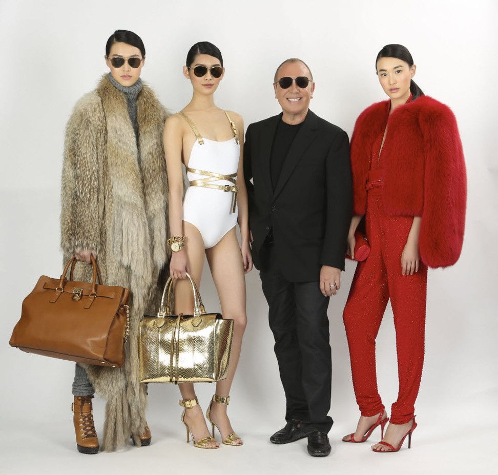 US designer Michael Kors with models at a fashion event in China.