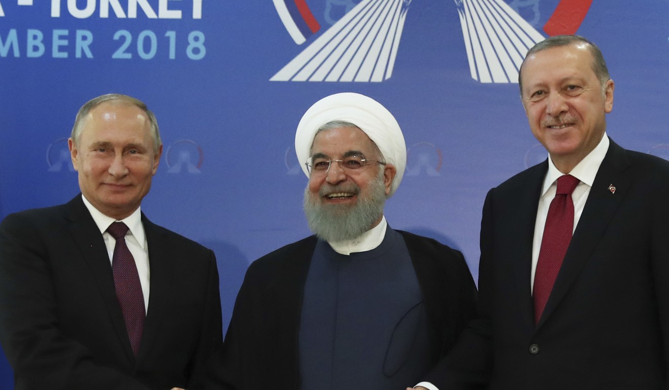 Iran's President Hassan Rowhani, centre, flanked by Russia's President Vladimir Putin, left, and Turkey's President Recep Tayyip Erdogan, pose for photographs in Tehran, Iran, ahead of their summit to discuss Syria, Friday, September 7, 2018. The three leaders began a meeting to discuss the war in Syria. (Presidential Press Service via AP, Pool)