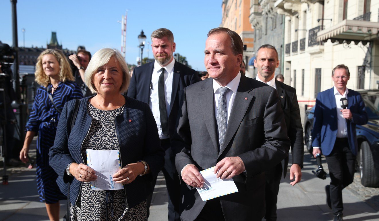Stefan Lofven arrives with his wife Ulla to cast their votes in Stockholm. Photo: AP