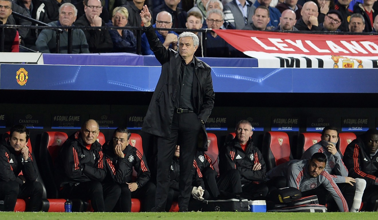 Manchester United's Portuguese coach Jose Mourinho gives instructions to his players in front of the away fans at Sevilla. Photo: AFP
