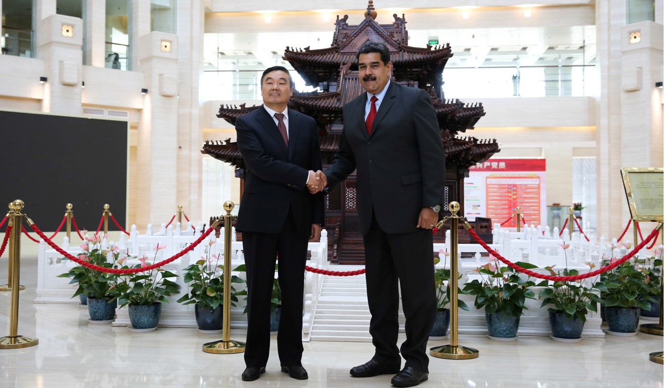 China Development Bank Chairman Hu Huaibang and Venezuela's President Nicolas Maduro shake hands during their meeting in Beijing on September 15. Photo: Reuters