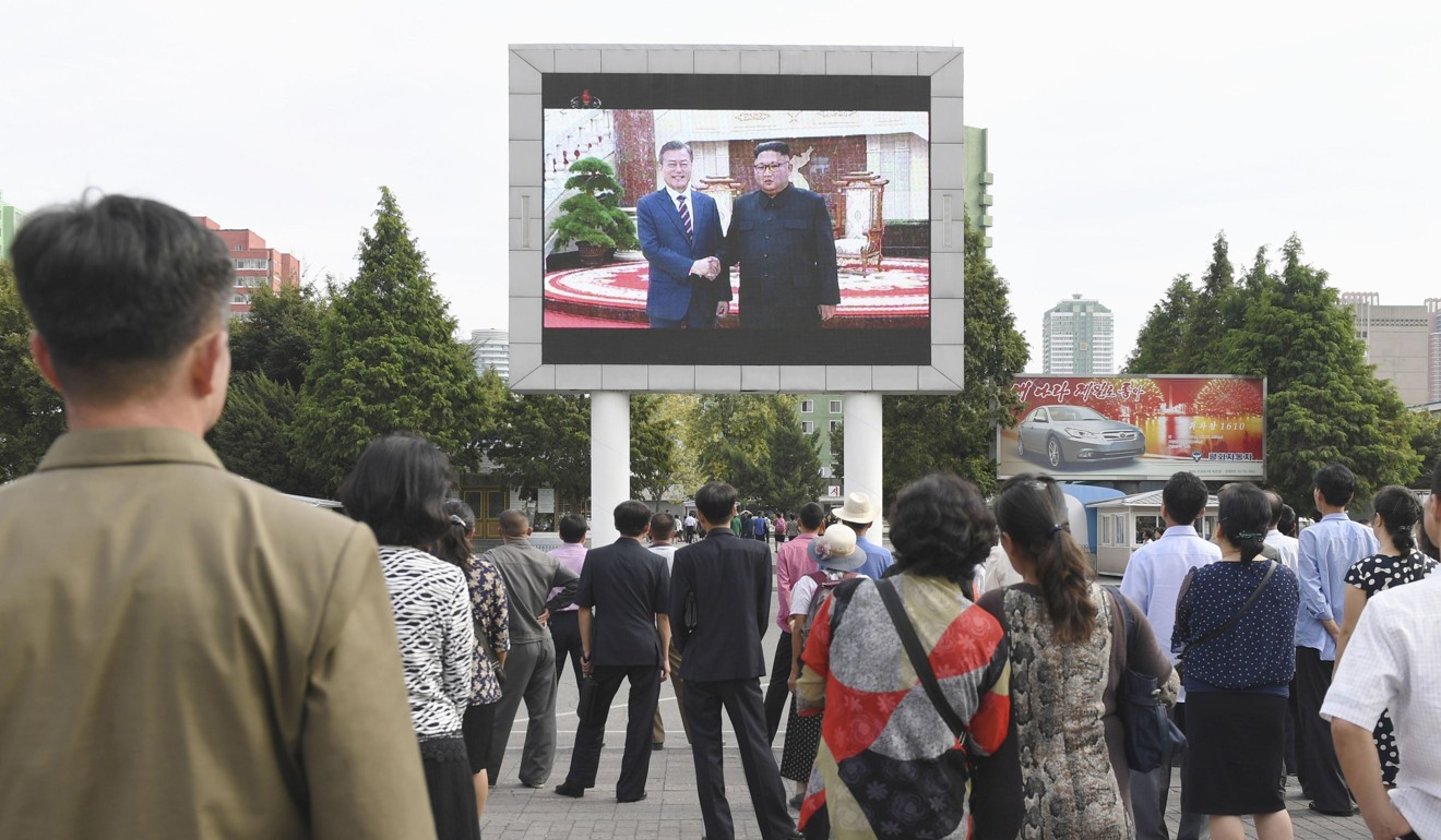 People look at a public screen set up near Pyongyang station showing the summit between Kim and Moon in Pyongyang. Photo: Kyodo