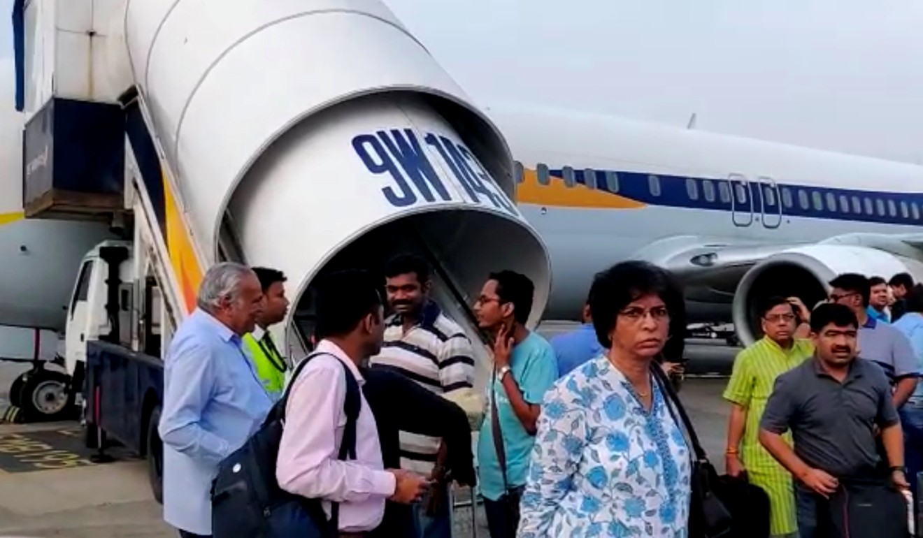 Passengers stand on the tarmac after an emergency landing because of lost cabin pressure on a Jet Airways flight in Mumbai. Photo: Reuters
