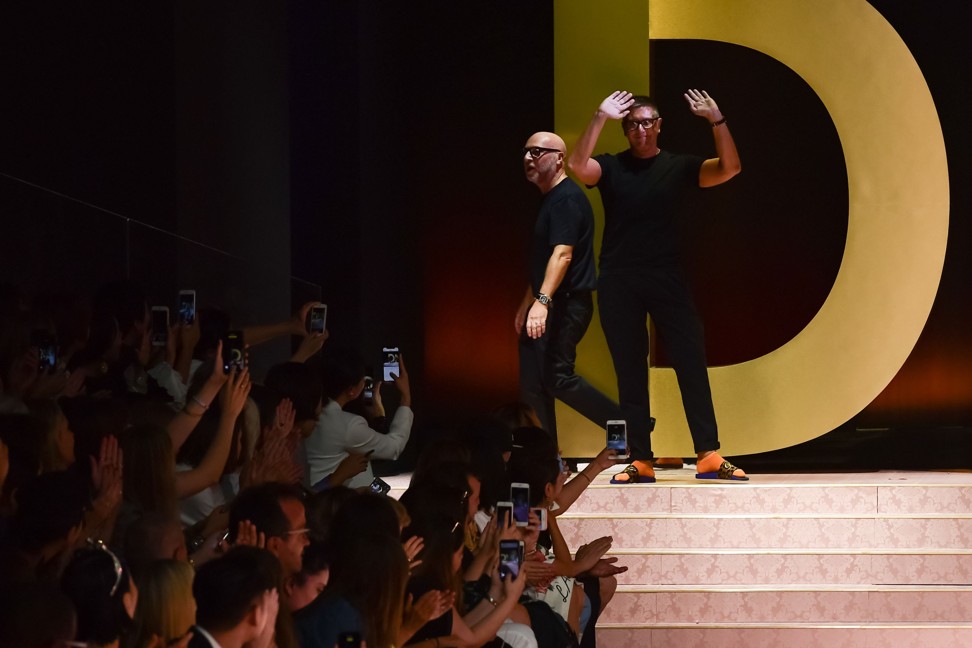 Italian fashion designers Domenico Dolce, left, and Stefano Gabbana acknowledge applause following the presentation. Photo: AFP