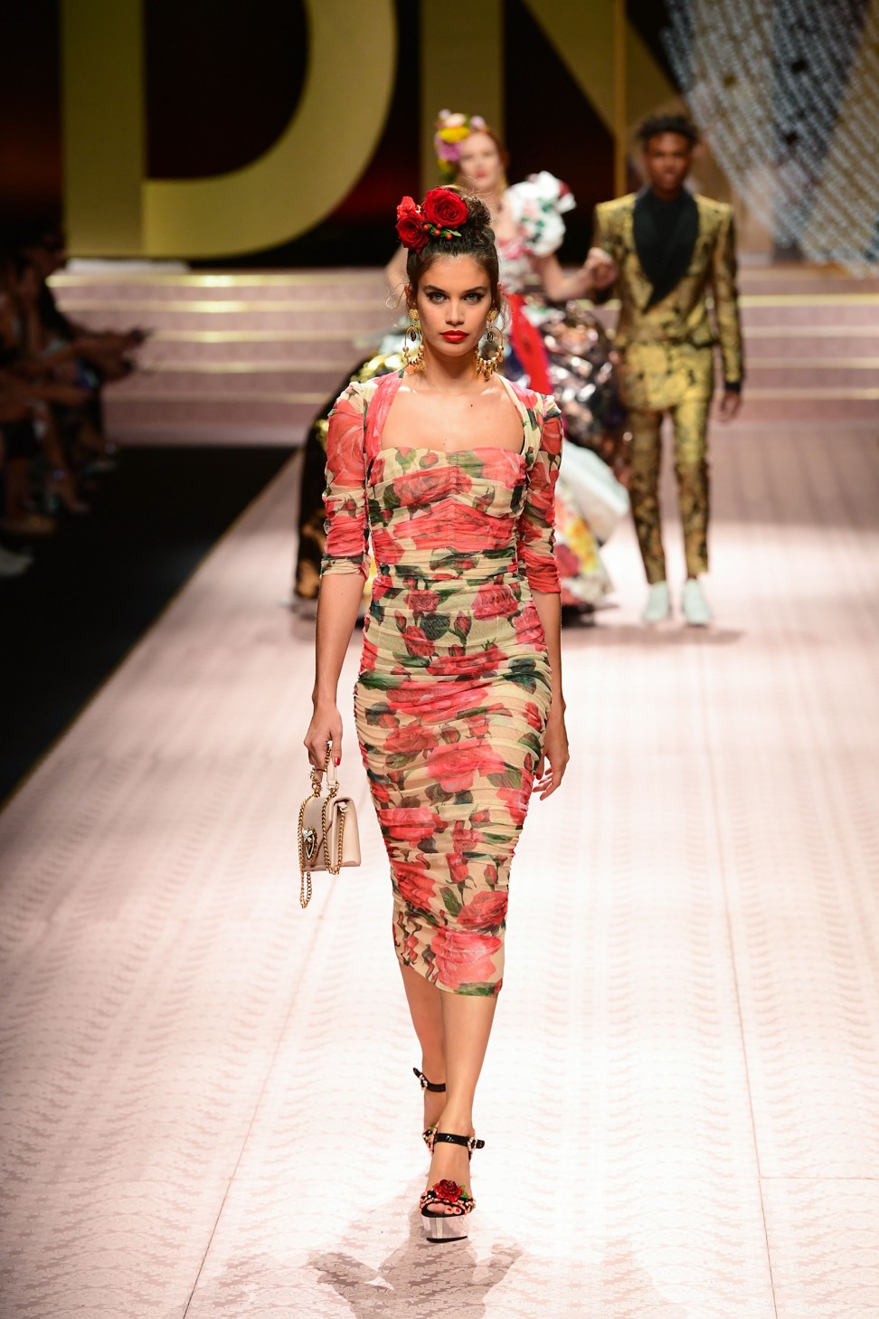 Portuguese model Sara Sampai was in the procession. Spring flowers featured as hair accessories and as prints and embellishment on long ruffled dresses. Photo: AFP