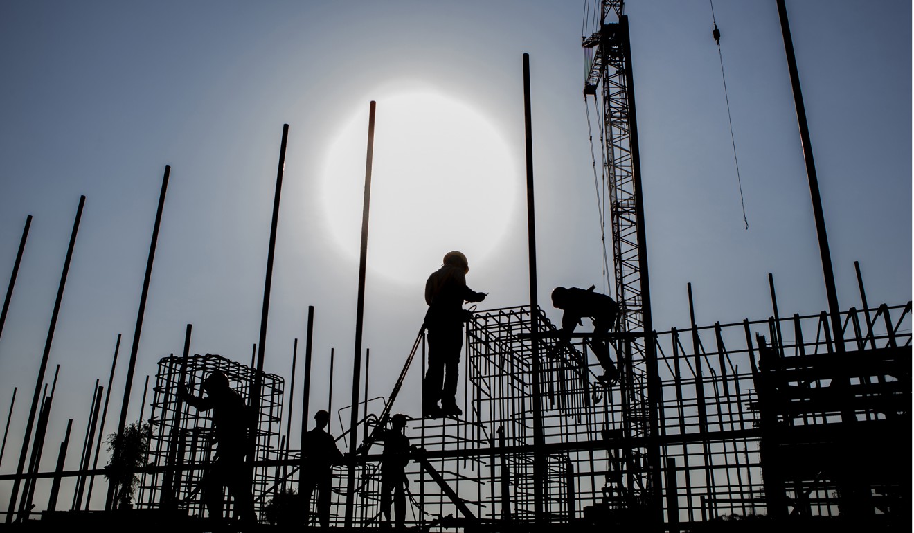 Workers in the Thar desert, Pakistan, build a Chinese-backed power plant. Photo: Bloomberg