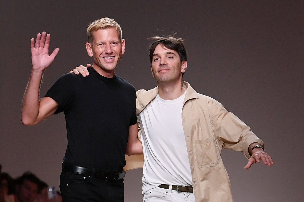 British fashion designer Paul Andrew (left) and French fashion designer Guillaume Meilland acknowledge the applause after the Salvatore Ferragamo fashion show in Milan. Photo: AFP