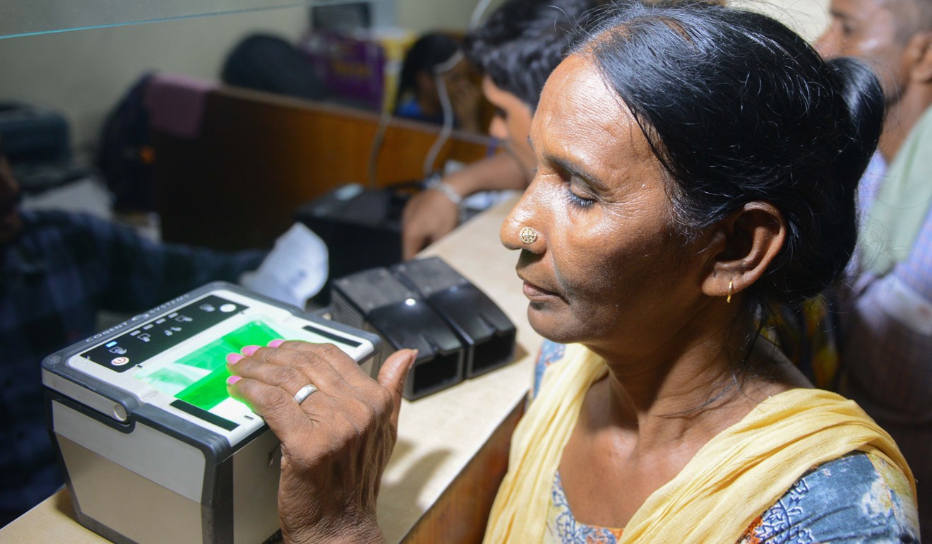 A woman getting her fingerprints scanned while registration for an Aadhaar card in Amritsar, India. Photo: AFP