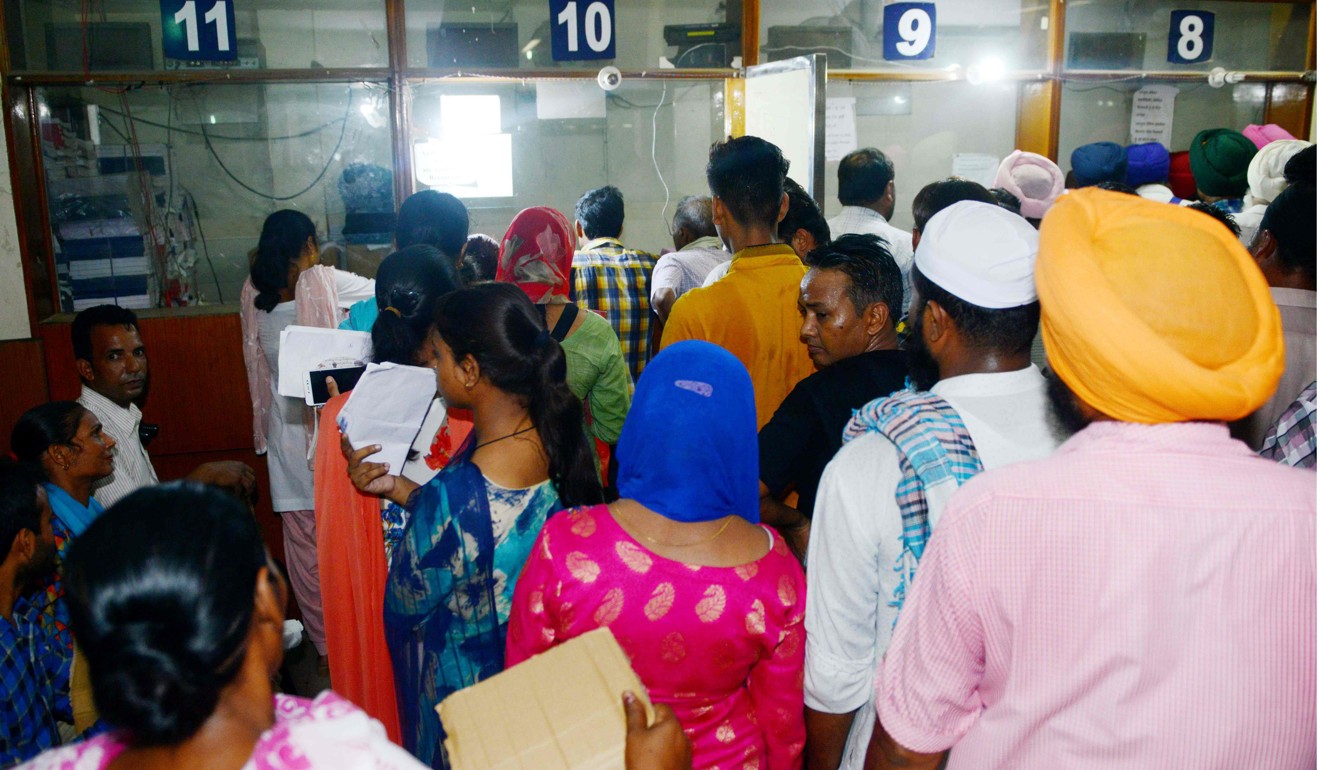 Indian people queuing up to register for Aadhaar cards. Photo: AFP