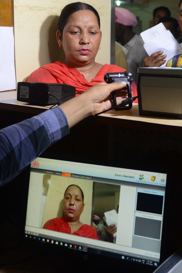 File photo of an Indian woman getting her picture taken during the registration process for Aadhaar cards. Photo: AFP