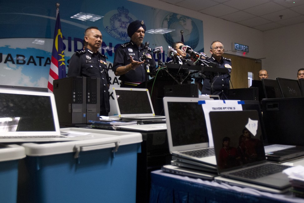 Commercial Crime Investigation Chief Amar Singh (centre) said his team was collaborating with Chinese authorities to determine the size of the losses. Photo: AP