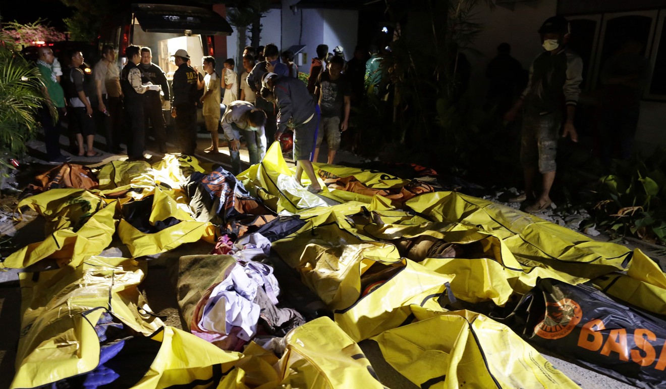 Bodies were lined up along the streets, some in bags and some with their faces covered with clothes. Photo: Reuters