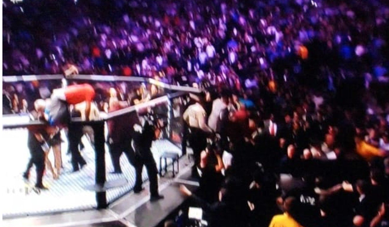 A member of Khabib Nurmagomedov’s encourage climbs over the fight to join in the melee. Photo: Handout