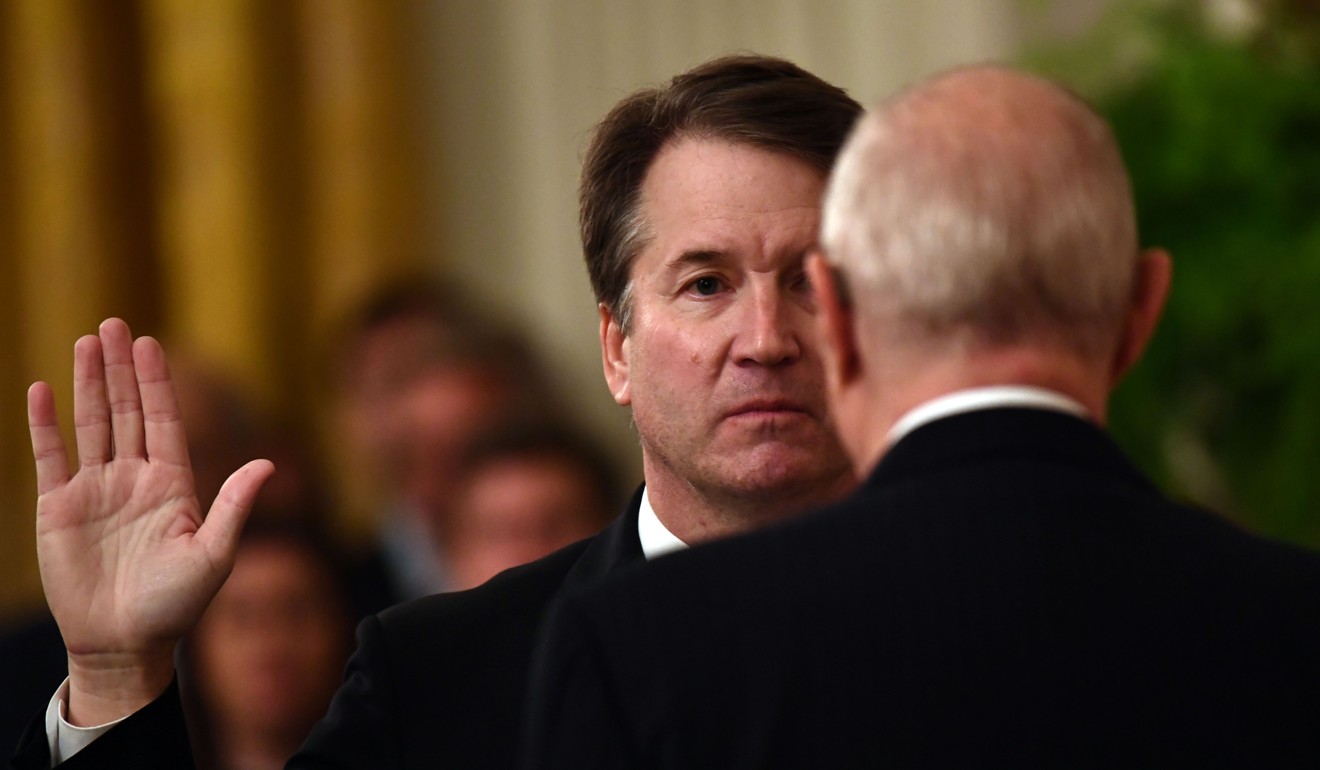 Brett Kavanaugh is sworn-in as Associate Justice of the US Supreme Court by Associate Justice Anthony Kennedy on Monday. Photo: AFP