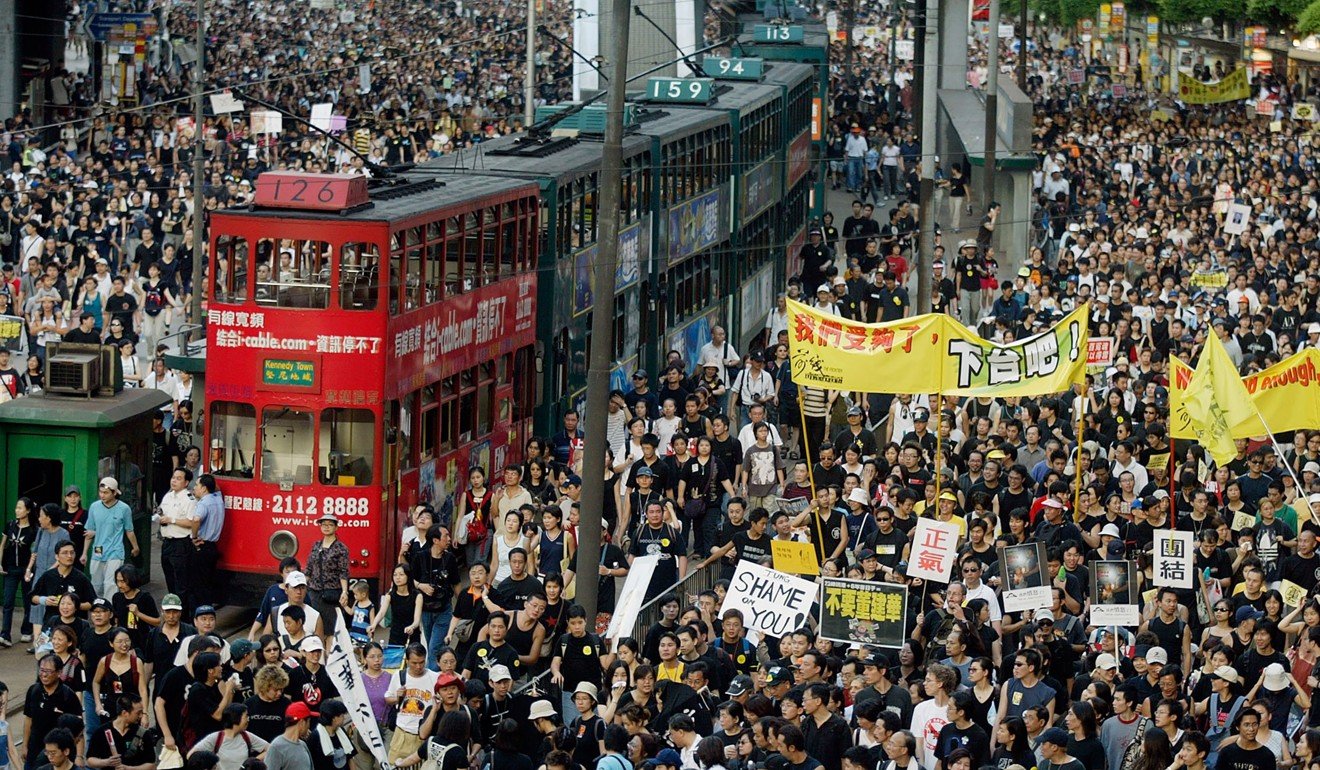 Thousands of people block the streets during a protest against the passage of a national security law in July 2003. Photo: AFP