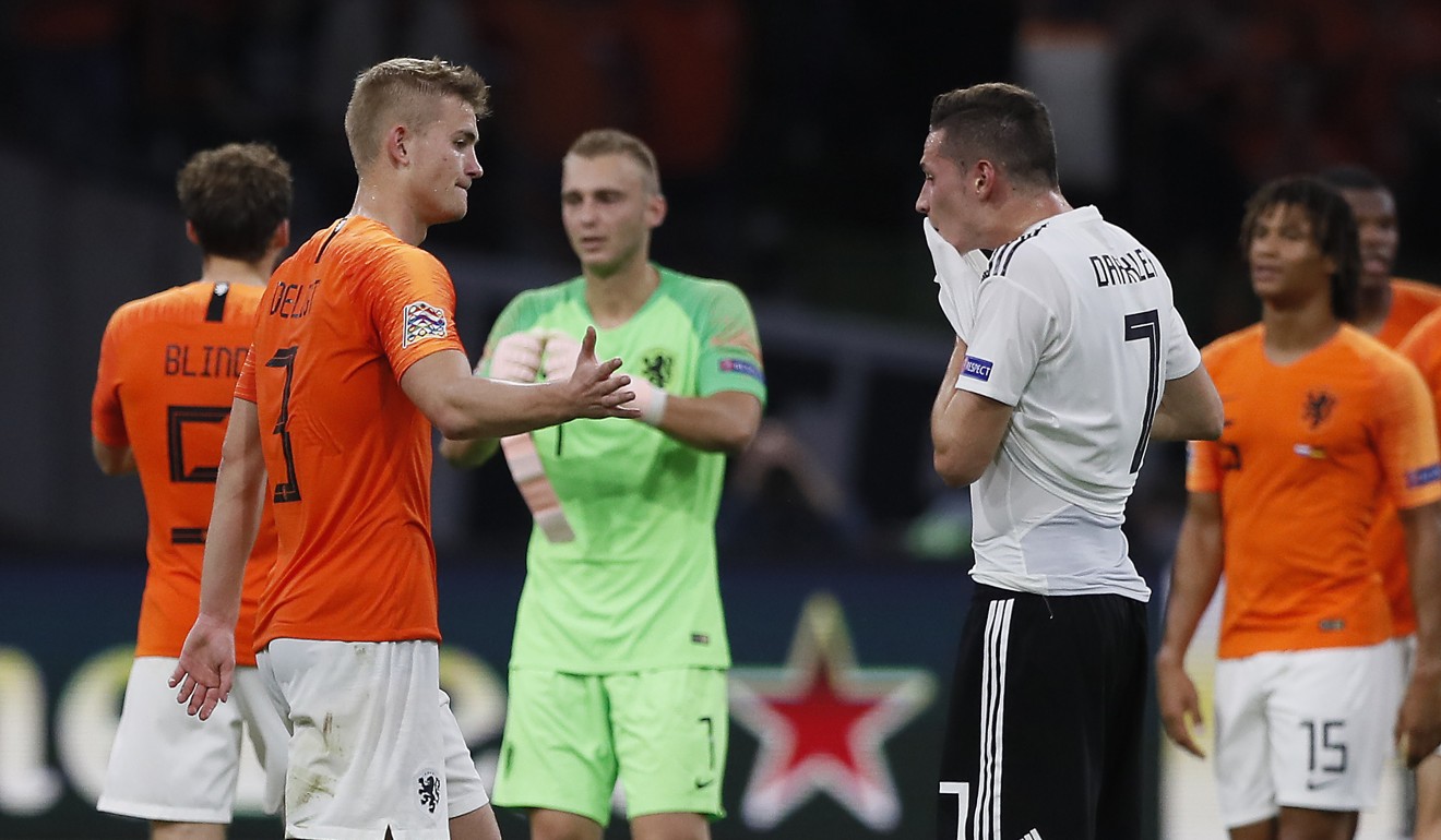 Germany’s Julian Draxler (right) reacts after the loss to Netherlands. Photo: AP
