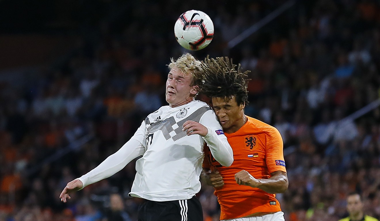 Germany’s Julian Brandt in a challenge with Netherland’s Nathan Ake. Photo: AP