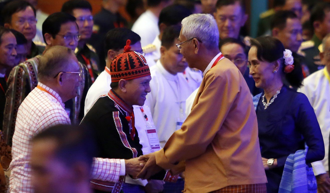 Myanmar’s President Htin Kyaw and Myanmar State Counsellor Aung San Suu Kyi greet ethnic rebel leaders during a signing ceremony for a ceasefire agreement in February. Photo: AFP.