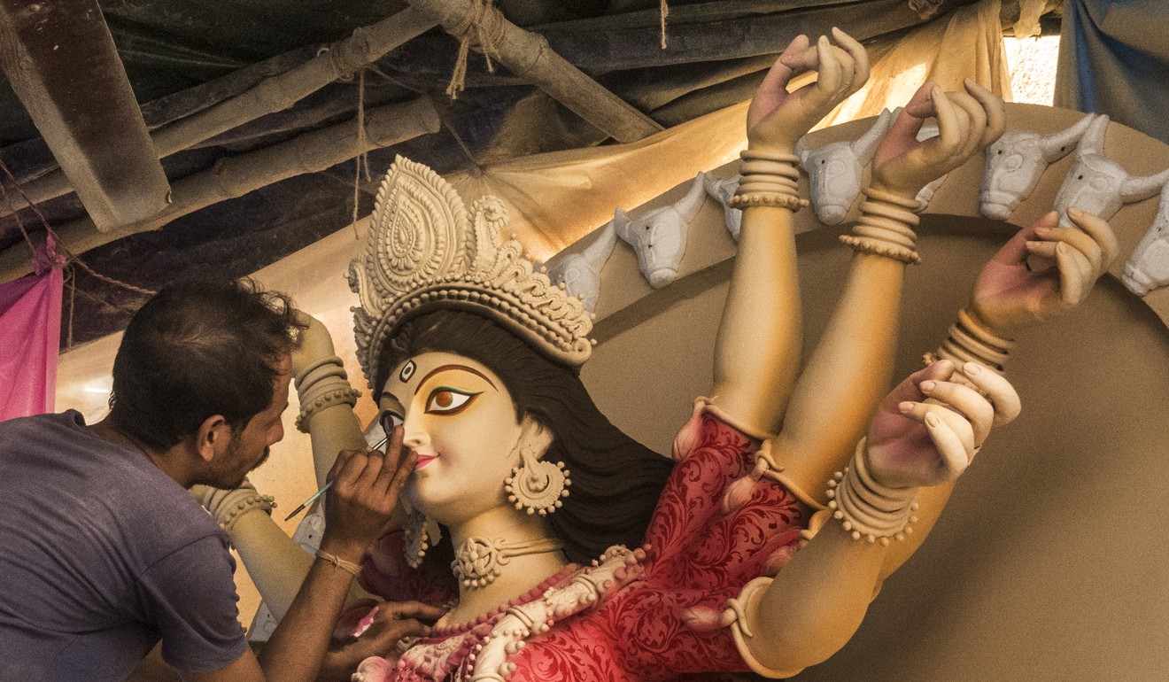 An artist puts the finishing touches to a clay idol of the goddess Durga ahead of the festival in Kolkata. Photo: Xinhua