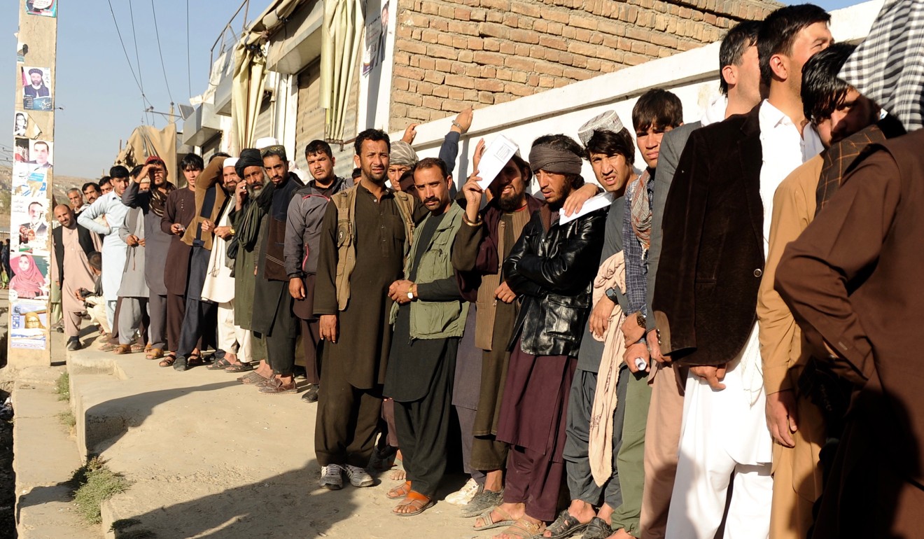 Afghan men stand line to cast their votes outside a polling centre in Kabul, Afghanistan, on Saturday. Photo: EPA