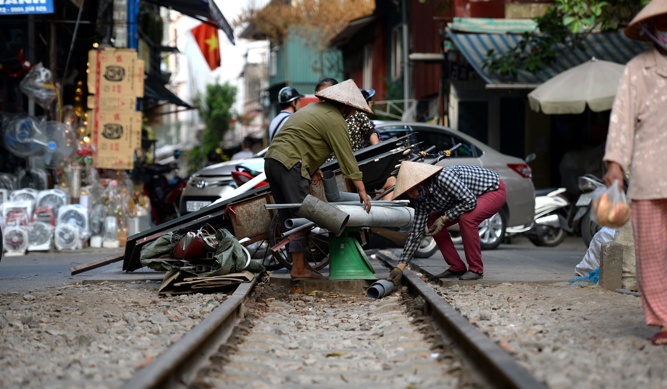 A Vietnamese scrap vendor doing business in the middle of a railway track. Photo: AFP