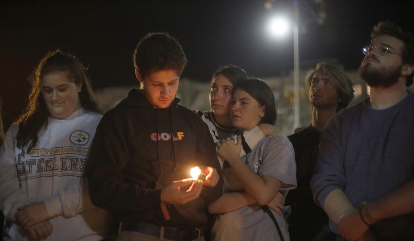 People light candles in Tel Aviv, Israel, in a commemoration of the victims. Photo: AP Photo
