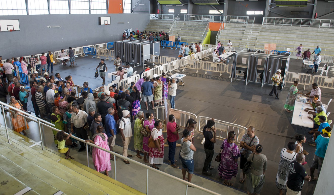 Residents of New Caledonia's capital, Noumea, wait in line at a polling station. Photo: AP