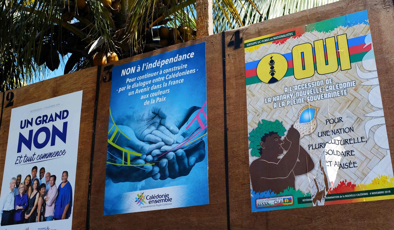 Boards with campaign posters by different political groups favouring or opposing New Caledonia’s independence. Photo: AFP