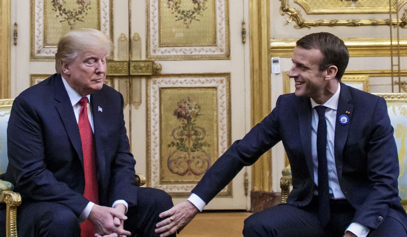 French President Emmanuel Macron pats US President Donald Trump on the leg during their meeting at the Elysee palace in Paris. Photo: EPA