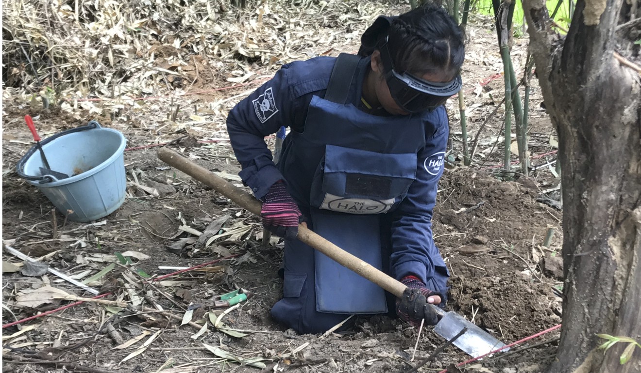 A member of the Halo team digs for an item that set off her metal detector. Picture: Padraic Convery