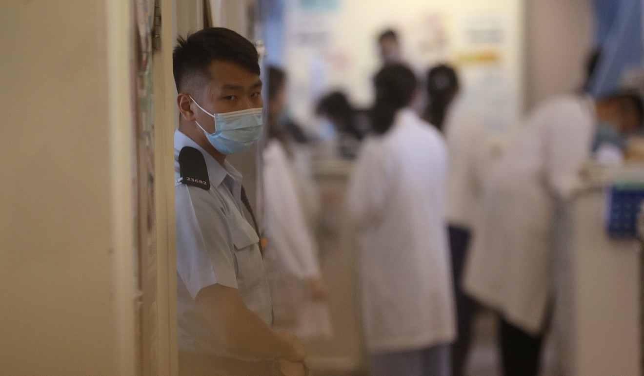 A police officer stands guard outside the A2 Medicine Ward on the second floor of the main block at Queen Mary Hospital from which Li escaped. Photo: Edward Wong