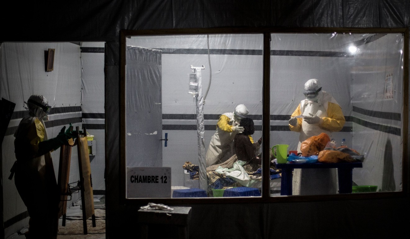 Health workers treat an unconfirmed Ebola patient, inside a MSF (Doctors Without Borders) supported Ebola Treatment Centre (ETC). Photo: AFP