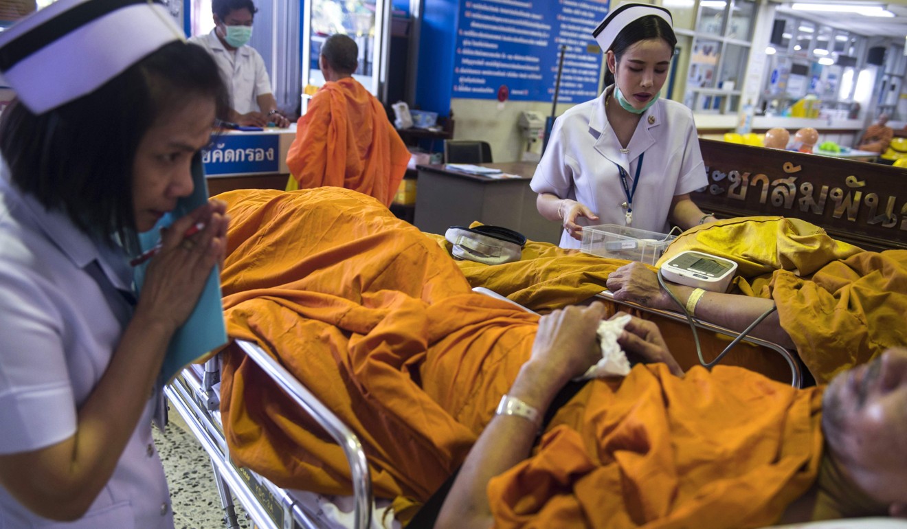 Nurses attend to a patient at a government-run hospital for Buddhist monks in Bangkok. Photo: AFP