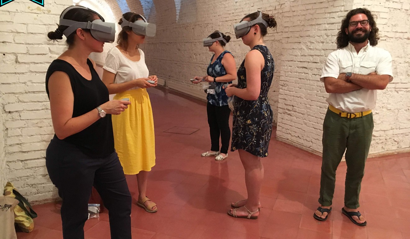 Visitors to the Rome Reborn project use virtual reality goggles to view a digital reconstruction of Rome. Photo: AFP