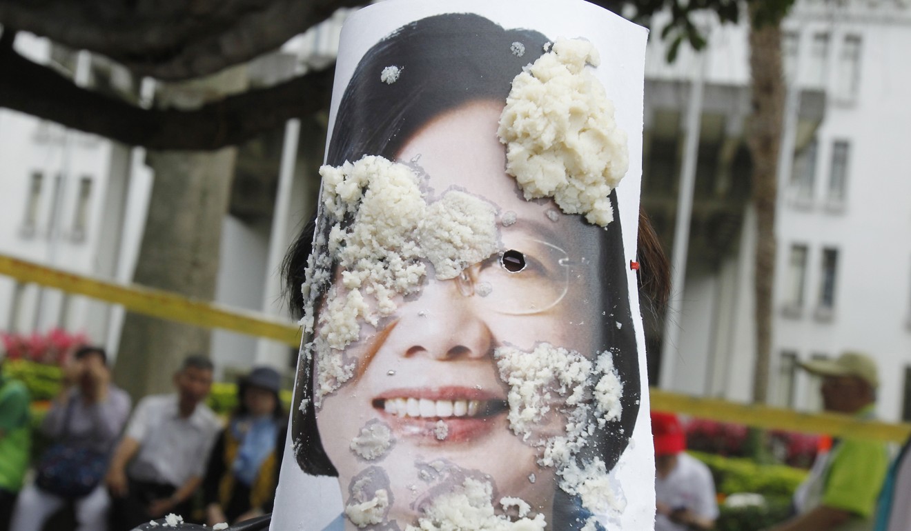Taiwanese workers throw bean curd at performers acting as Taiwanese President Tsai Ing-wen and other officeholders during a Labour Day rally in Taipei, Taiwan, on May 1, 2017, as they demand better conditions for workers in Taiwan. Changes to Taiwan’s labour laws turned many workers against the DPP. Photo: AP