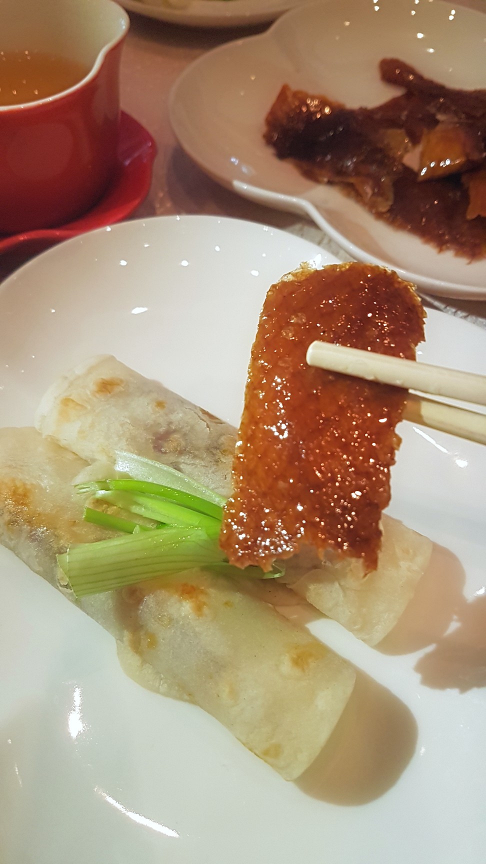 Peking duck often involves the crispy skin and duck meat being served wrapped in pancakes and served with cucumber and a sweet bean sauce. Photo: Cedric Tan